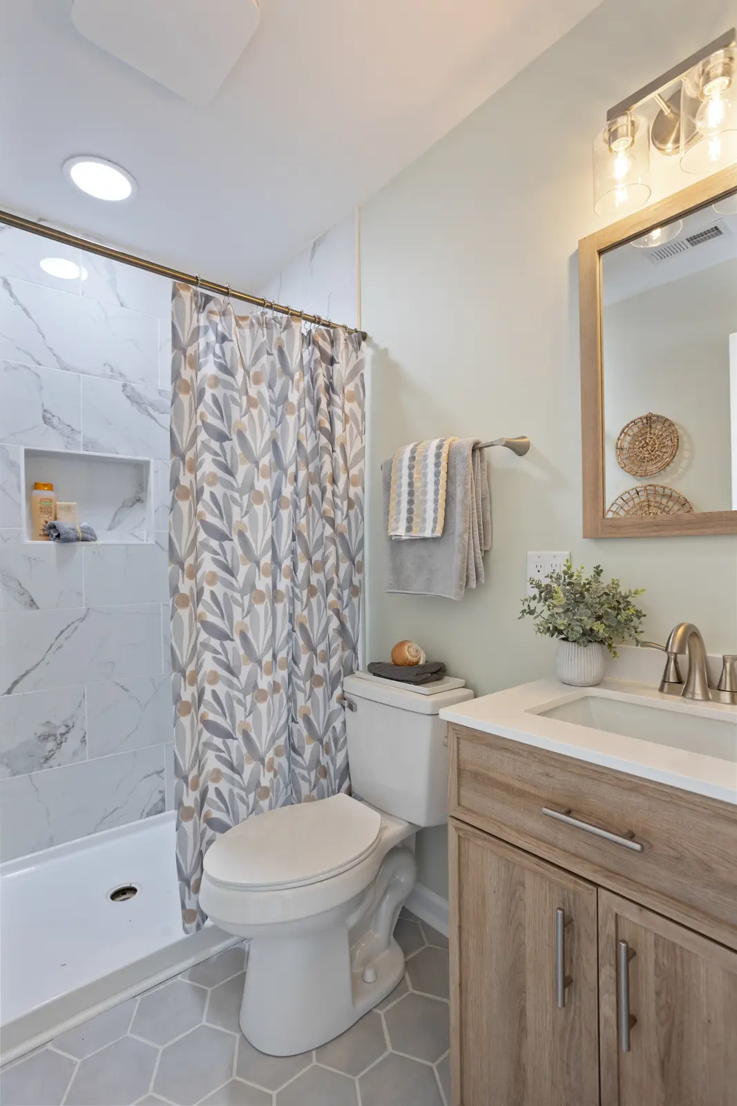 Remodeled Wilmington bathroom with tiled shower and new vanity