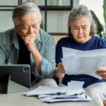 senior couple looking at paperwork to avoid foreclosure on your corpus christi house