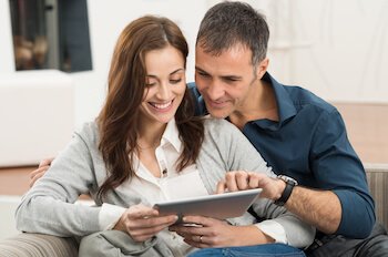Man and woman look at a tablet