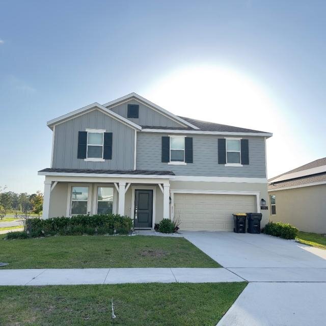 Front of 1002 John Jacob Rd in Davenport, showing the two-story home, garage, driveway and lawn