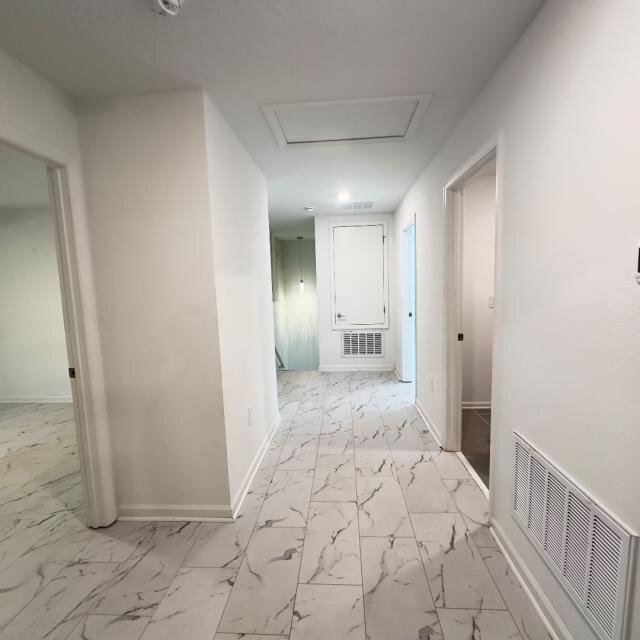 Hallway at 1002 John Jacob Rd with light walls and patterned tile flooring