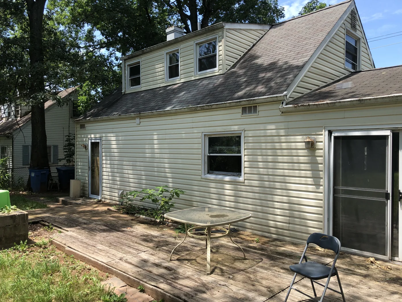 Rear of the house with dormer windows and a wood deck