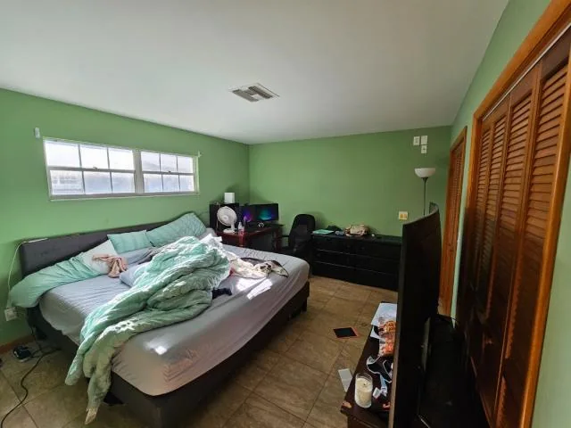 Bedroom at 1499 Van Eck Rd NE in Palm Bay, Florida, in original condition