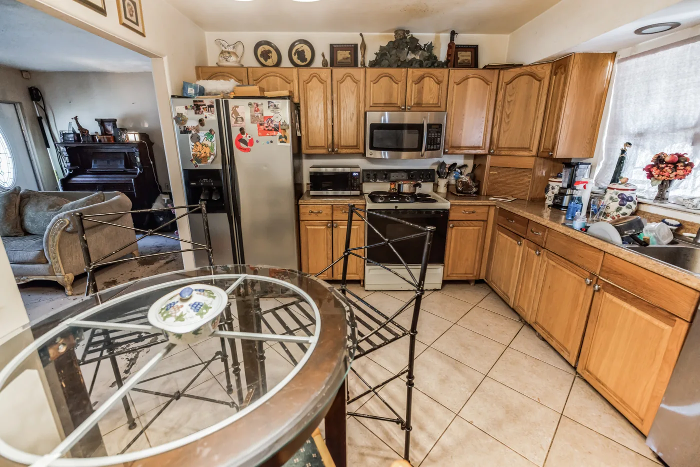Kitchen with wood cabinets, tiled floor and a small dining table