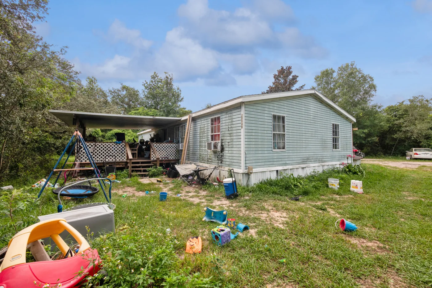 Mobile home and yard with scattered belongings