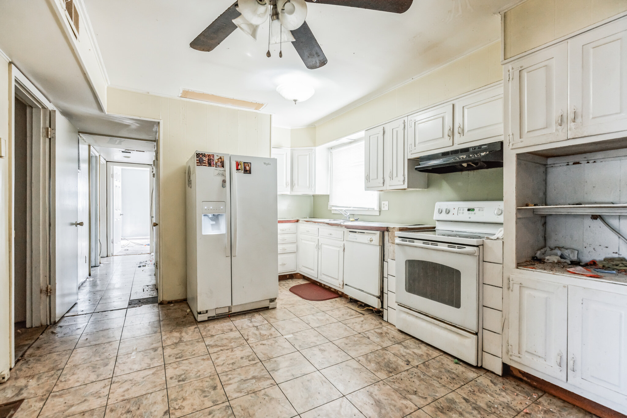 Kitchen at 22519 Joan Dr before updates, showing older cabinets, appliances and flooring