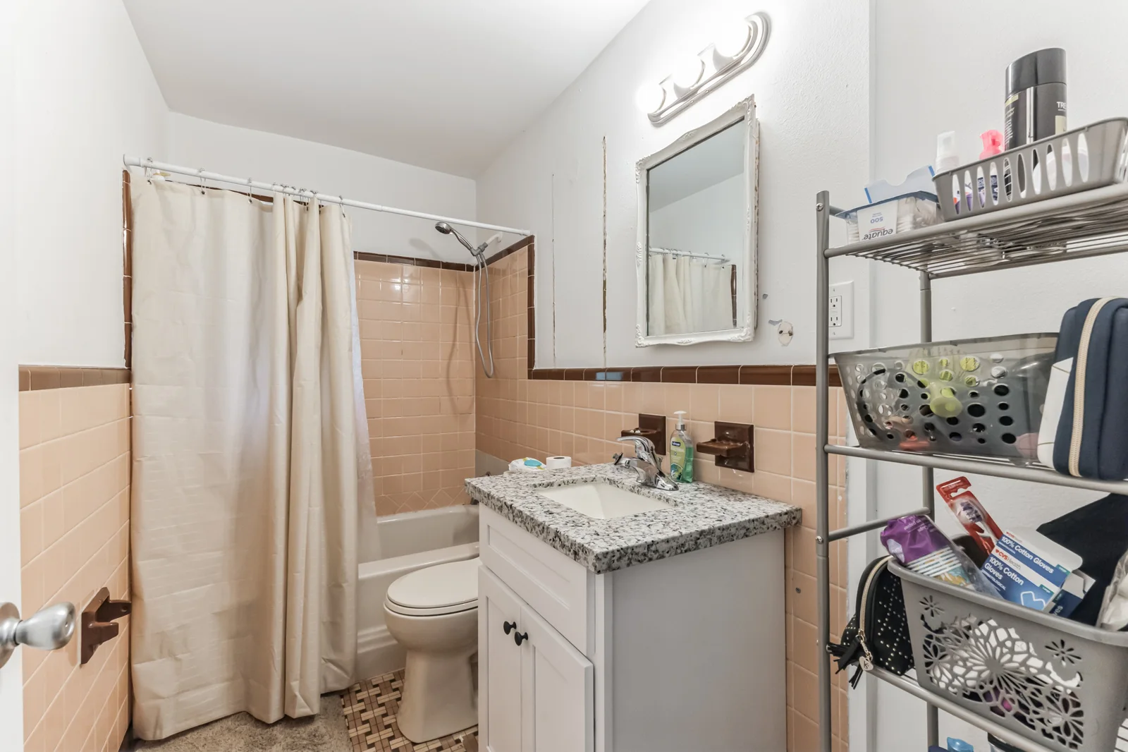 Bathroom at 2405 Howell Avenue with a tub, shower curtain and vanity