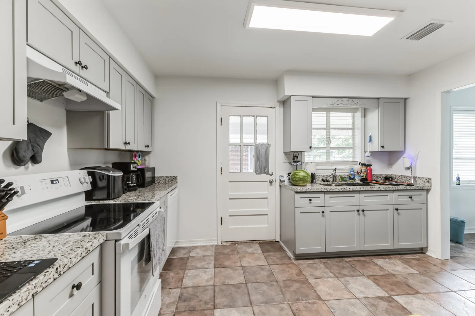 Kitchen at 2405 Howell Avenue with light cabinets and tile floor