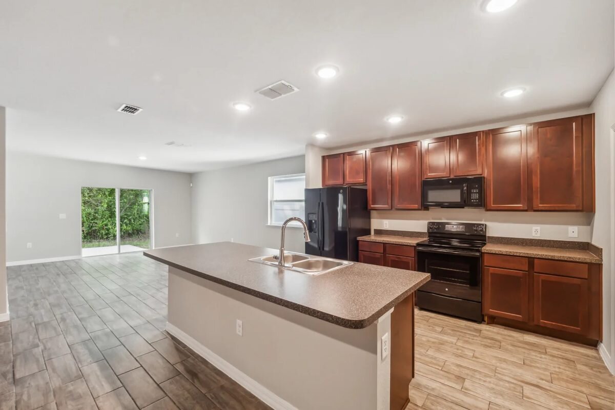 Living area and kitchen at 286 E Fiesta Key Loop in DeLand, Florida, after renovation