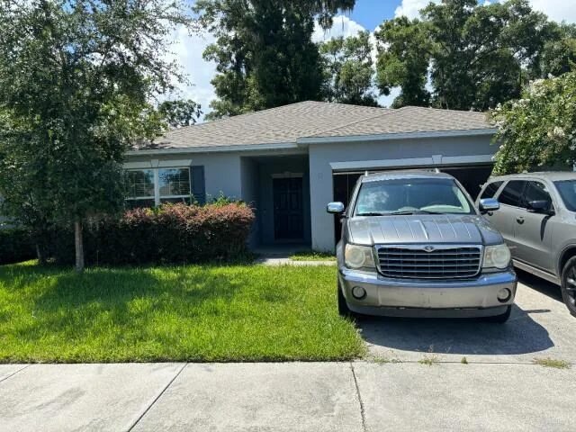Front exterior of 286 E Fiesta Key Loop in DeLand, Florida, before renovation