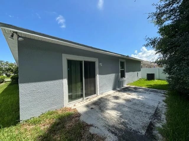 Rear exterior and patio at 286 E Fiesta Key Loop in DeLand, Florida, before renovation