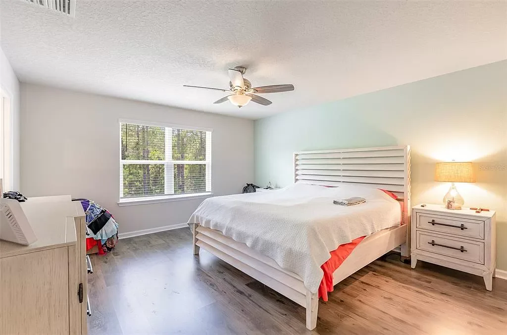 Bedroom with wood-look flooring and a ceiling fan at 321 Crest Wind Dr, Daytona Beach