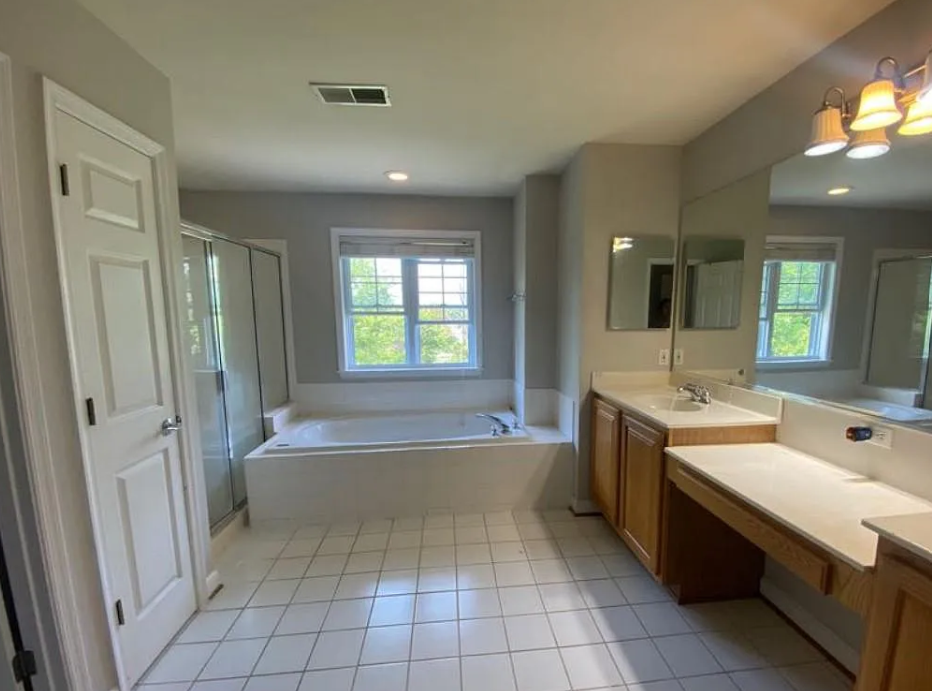 Bathroom at 5823 Montgomery Rd with a double vanity, tiled floor and bathtub