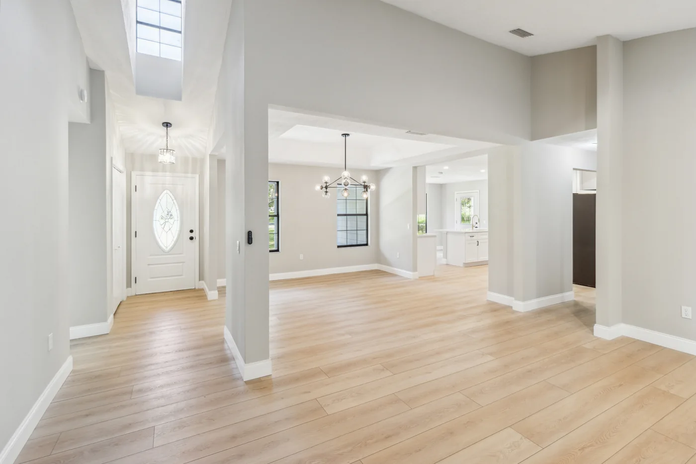 Renovated entry and living area with light wood-look flooring