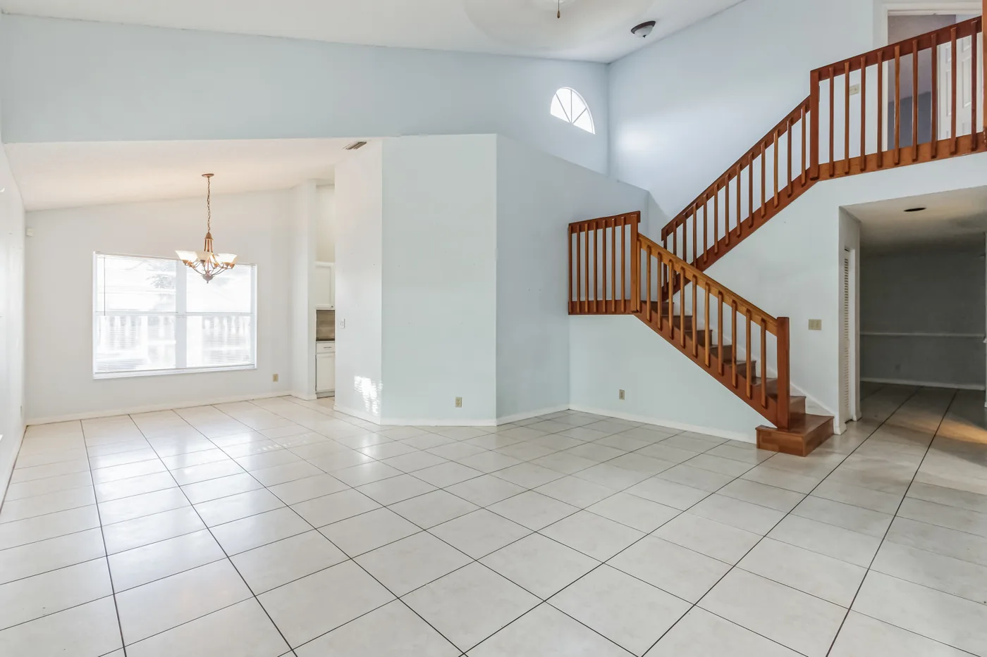 Living area with tile flooring and a staircase after renovation at 7403 Ashley Shores Circle, Lake Worth