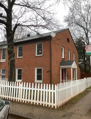 Brick exterior and white fence at 9764 Bragg Lane in Manassas