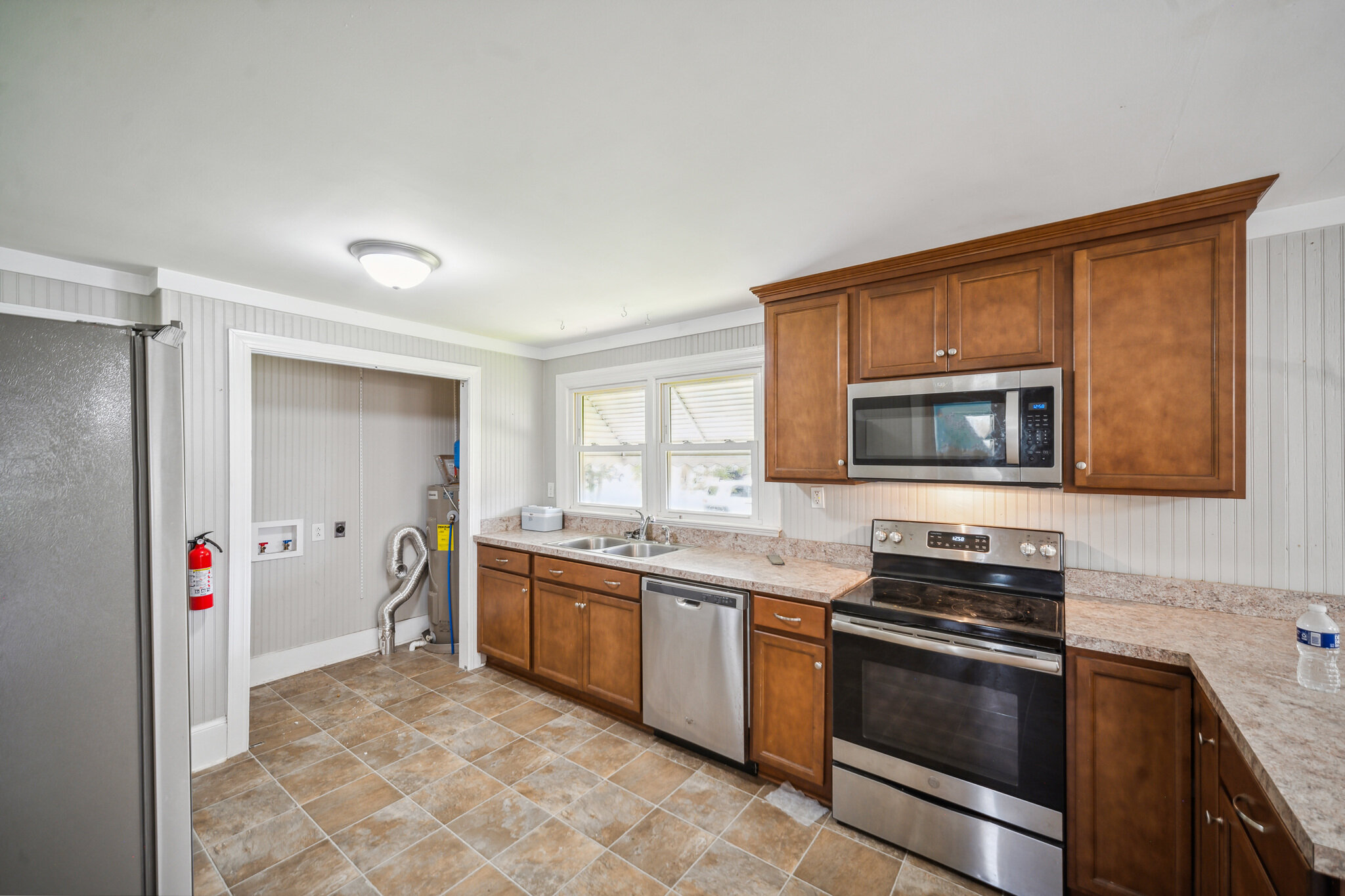 Kitchen at 107 Cedar St in Colerain, with wood cabinets and appliances