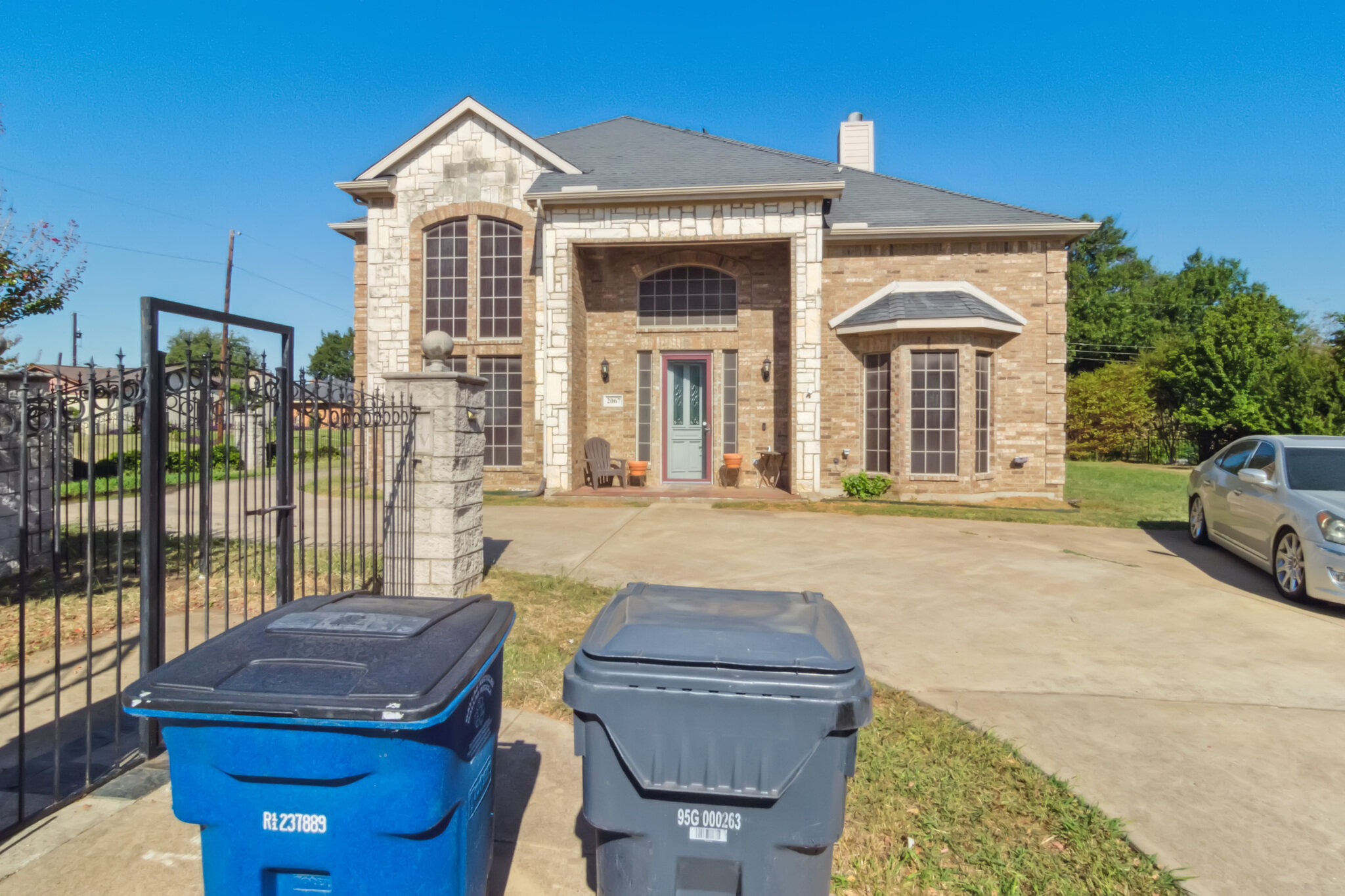 Front exterior, gated entrance and driveway at 2067 Chevella Dr in Dallas