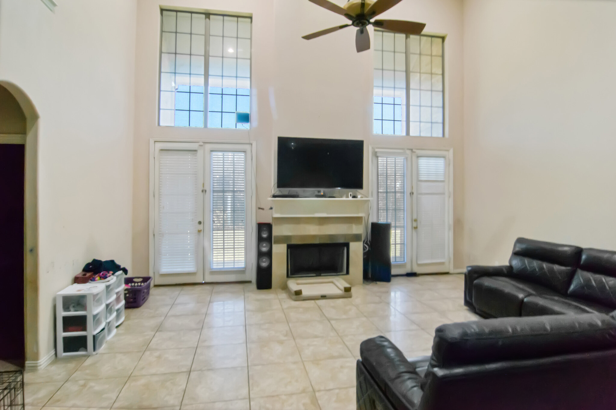 Living room with tall windows and fireplace at 2067 Chevella Dr in Dallas