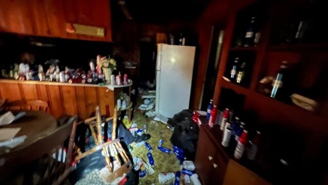 Kitchen at 517 Denton St with household items and debris before the estate sale
