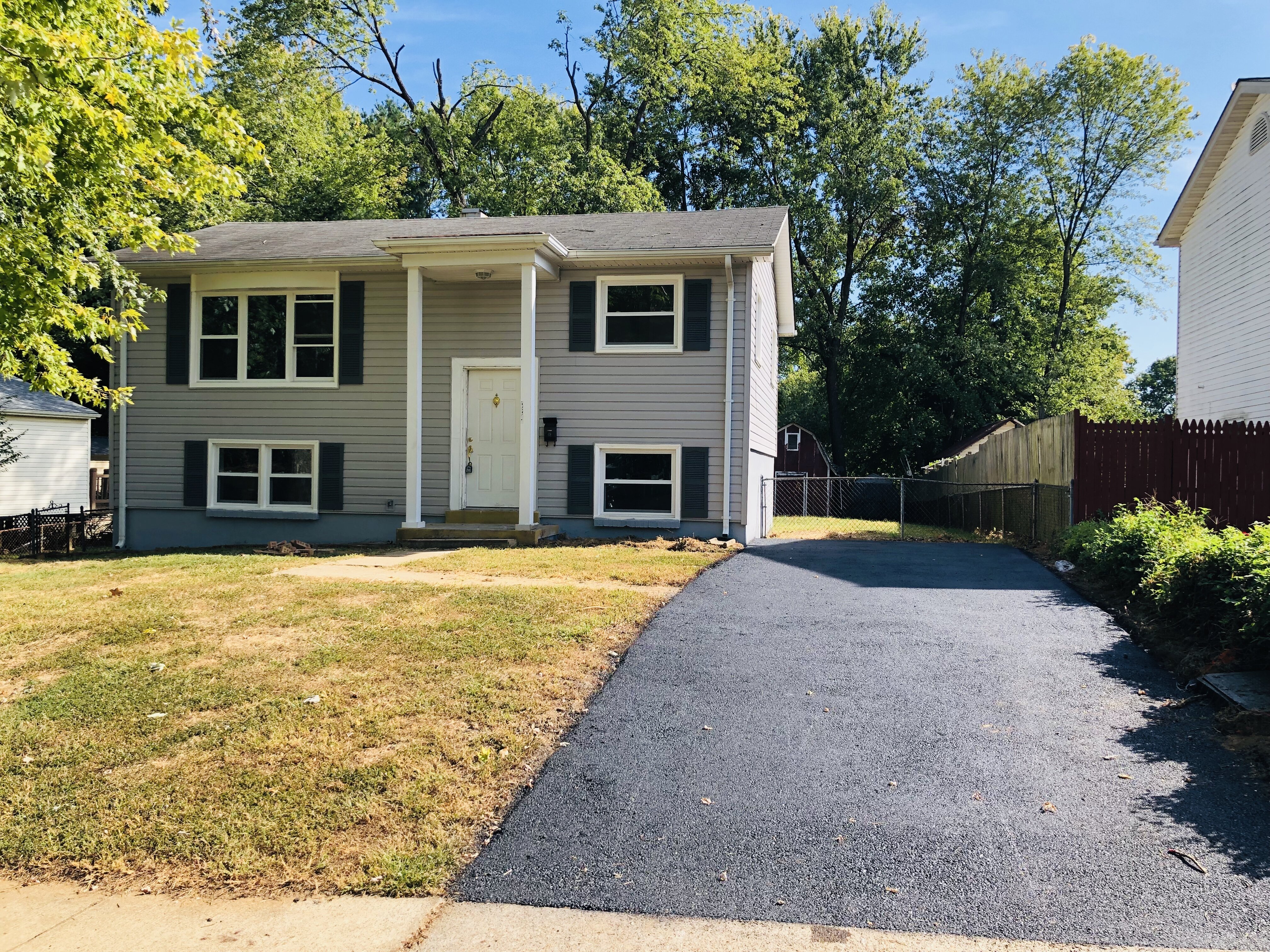 Front exterior and driveway of 14317 Ferndale Rd after updates