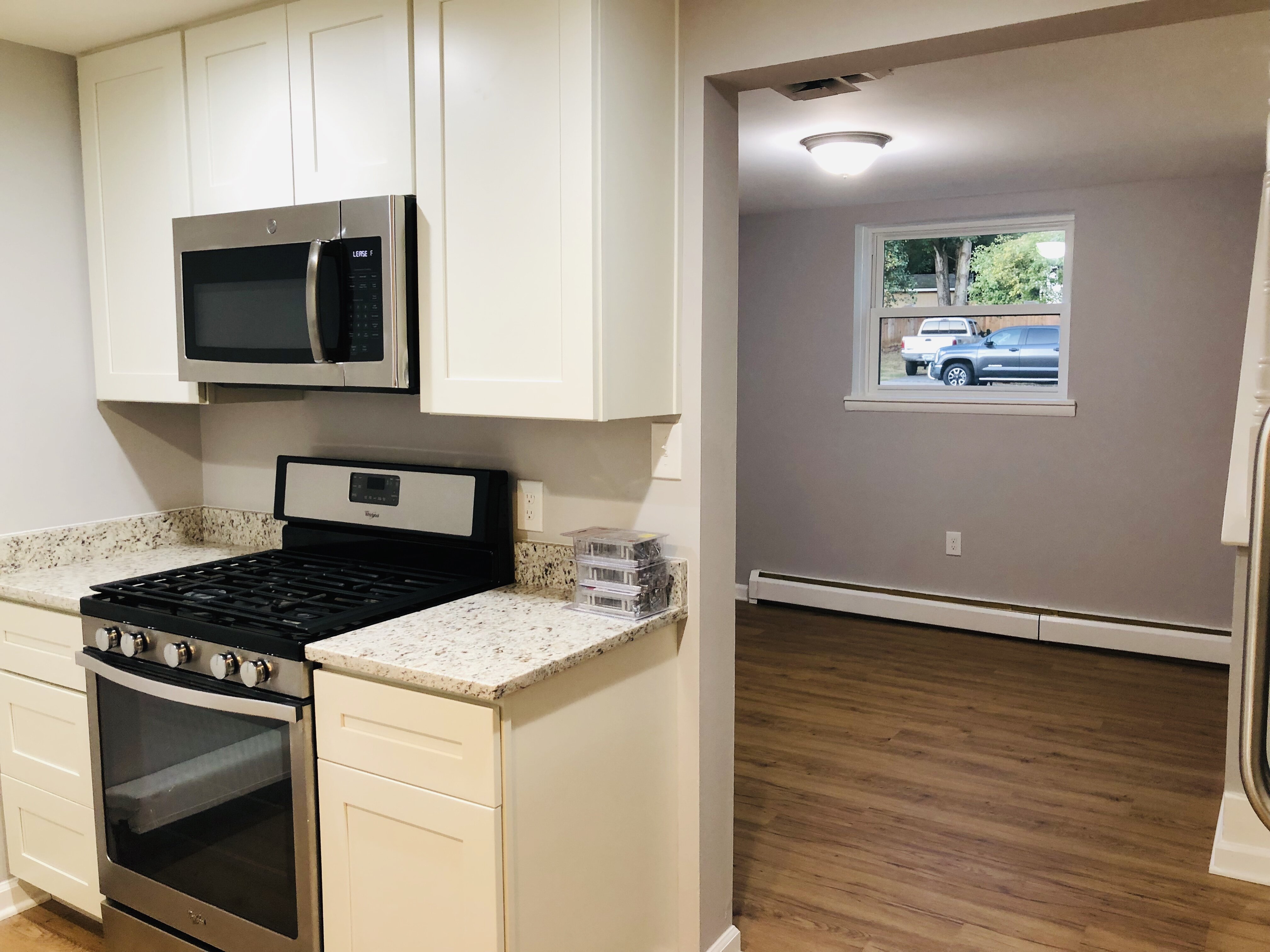Kitchen at 14317 Ferndale Rd after updates, with light cabinets and a gas range