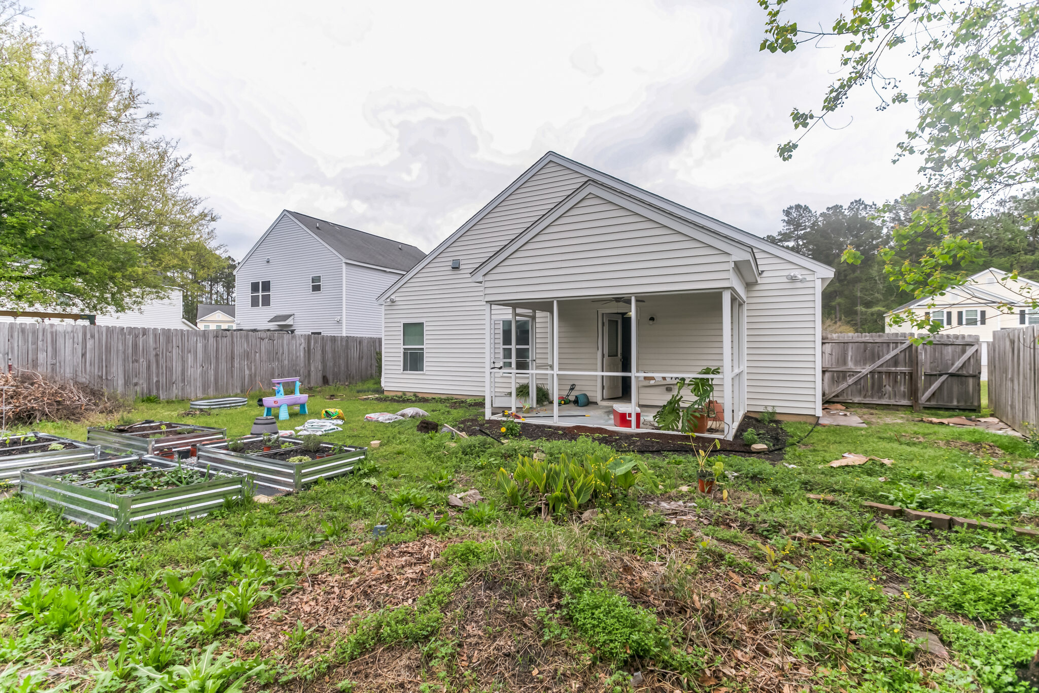 Rear yard and covered porch at 445 Lions Den Dr before cleanup
