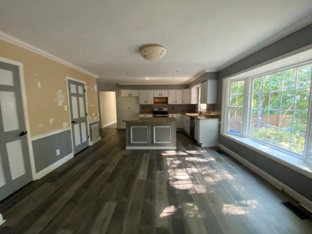 Kitchen and dining area at 2002 Pinewood Terrace before updates, with unfinished wall patches