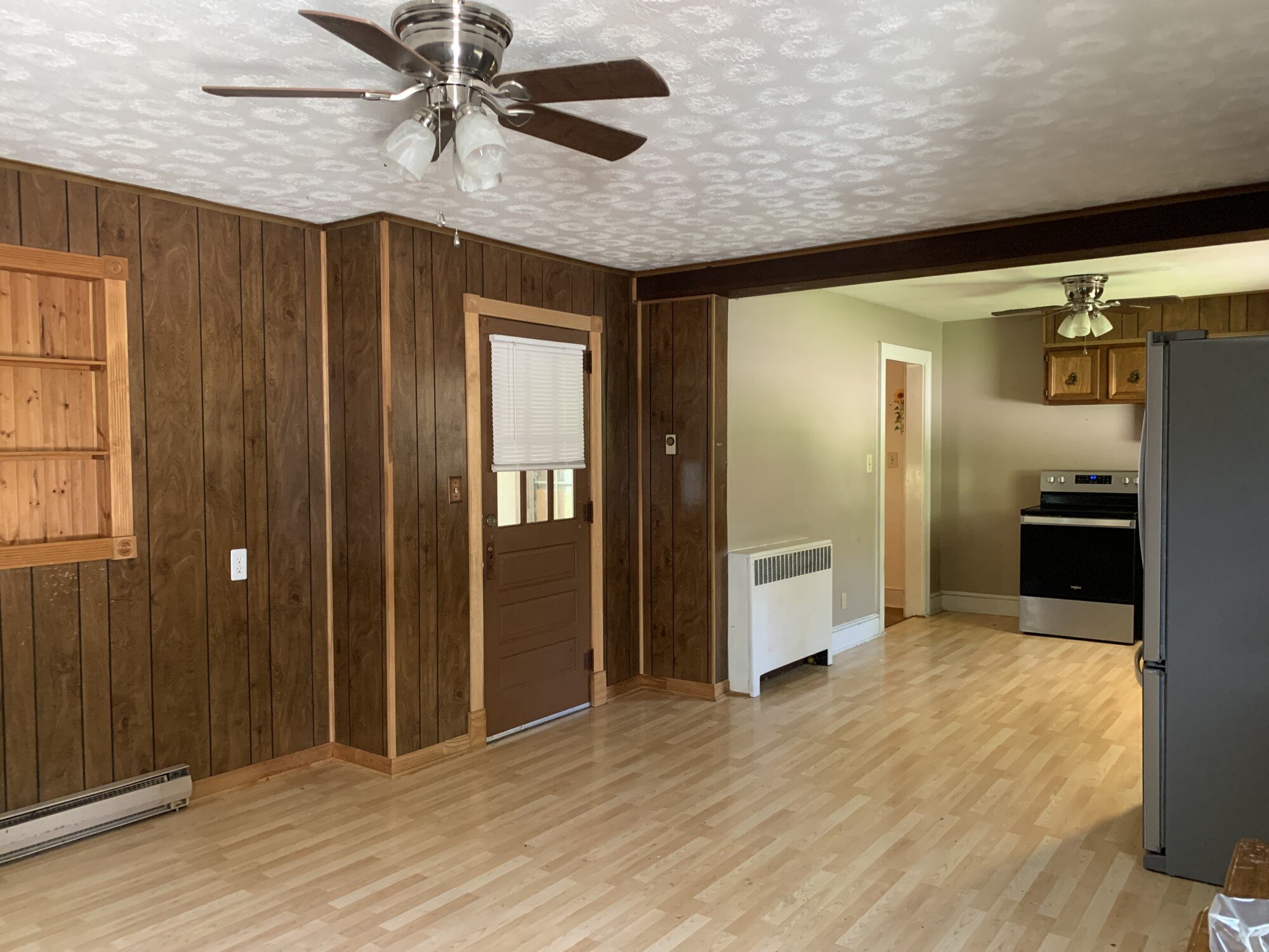 Wood-paneled room and adjoining kitchen at 390 N 5th St in Wytheville, Virginia