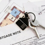 Keys on mortgage note and blueprints