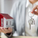 Real estate investment concept. Real estate agent with home insurance policy