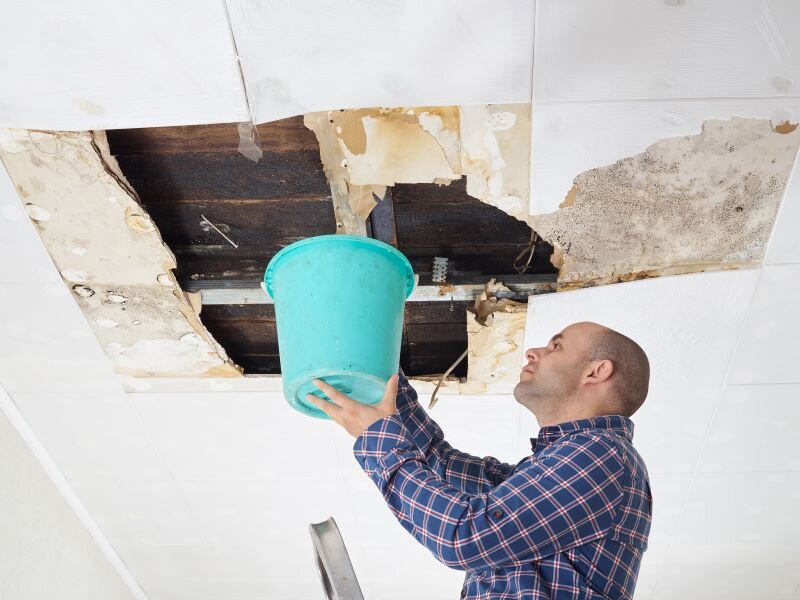 A man evaluates water damage made to the house.