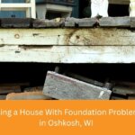 Cracked stone basement wall in an older Oshkosh home with foundation problems