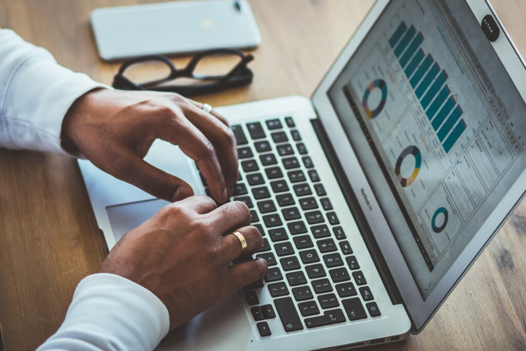 The Statistics of Home Selling in OH & KY and Northern Kentucky - man typing, charts on the screen