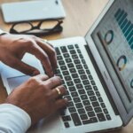 The Statistics of Home Selling in OH & KY and Northern Kentucky - man typing, charts on the screen