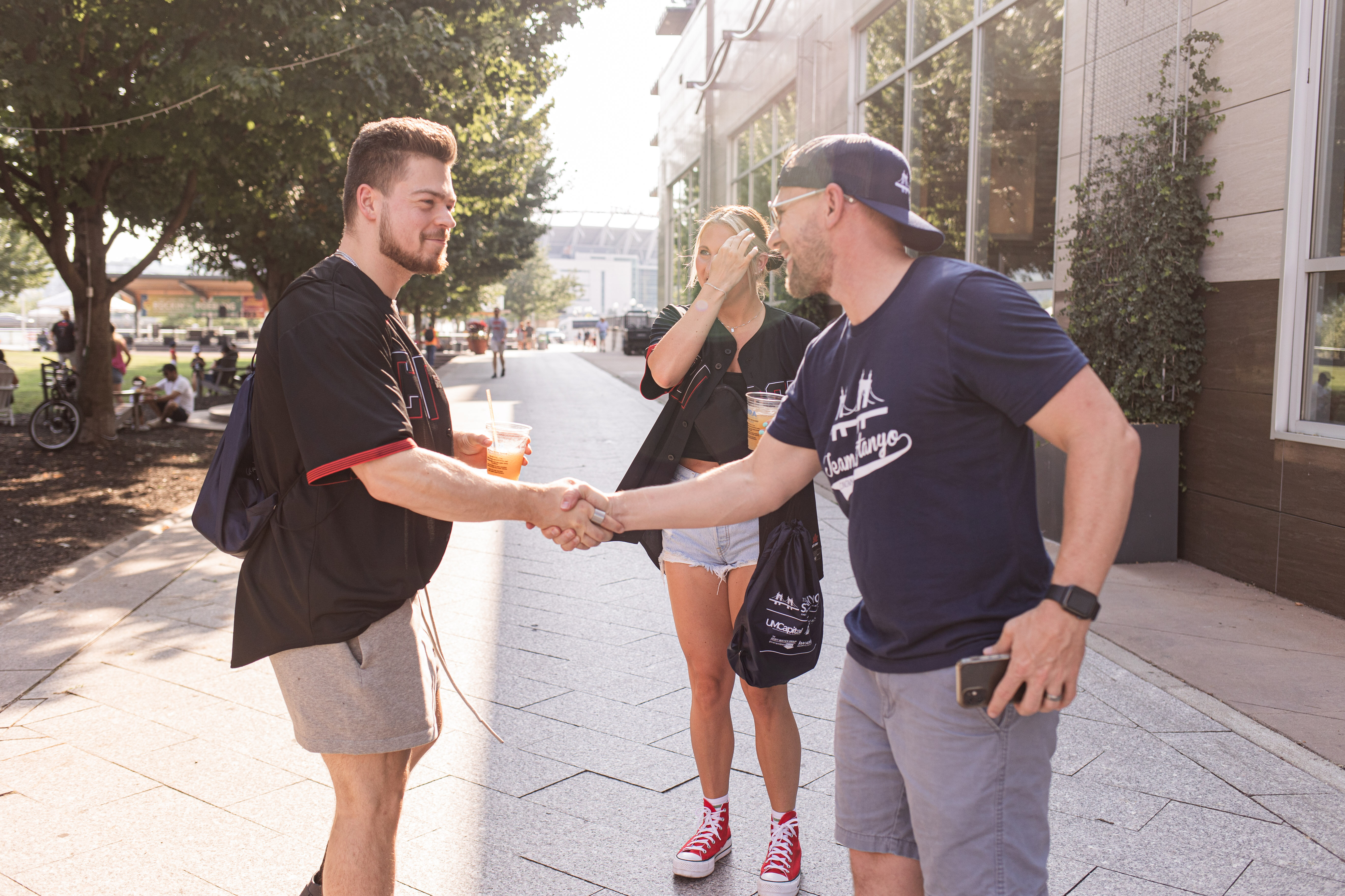 Eric Sztanyo shaking hands with a home buyer client at a Team Sztanyo Reds Game event