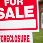 red sign board for sale foreclosure