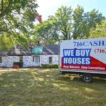 MRR Property Solutions renovation project on a brick home in Buffalo, NY, showing construction vehicles and exterior updates in progress.