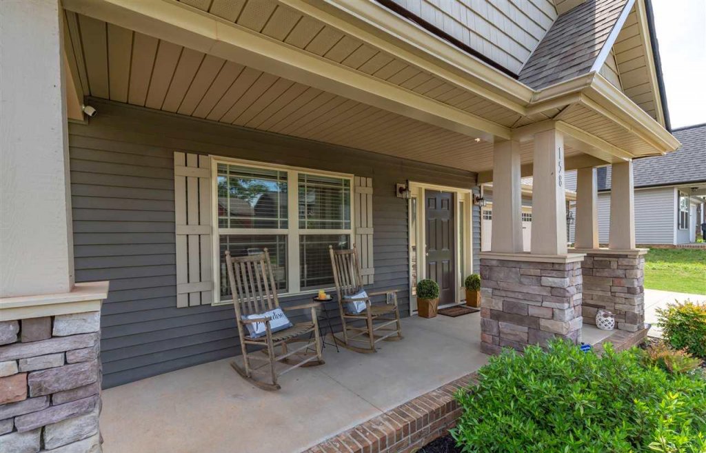 single story home in duncan sc with a porch and rocking chairs