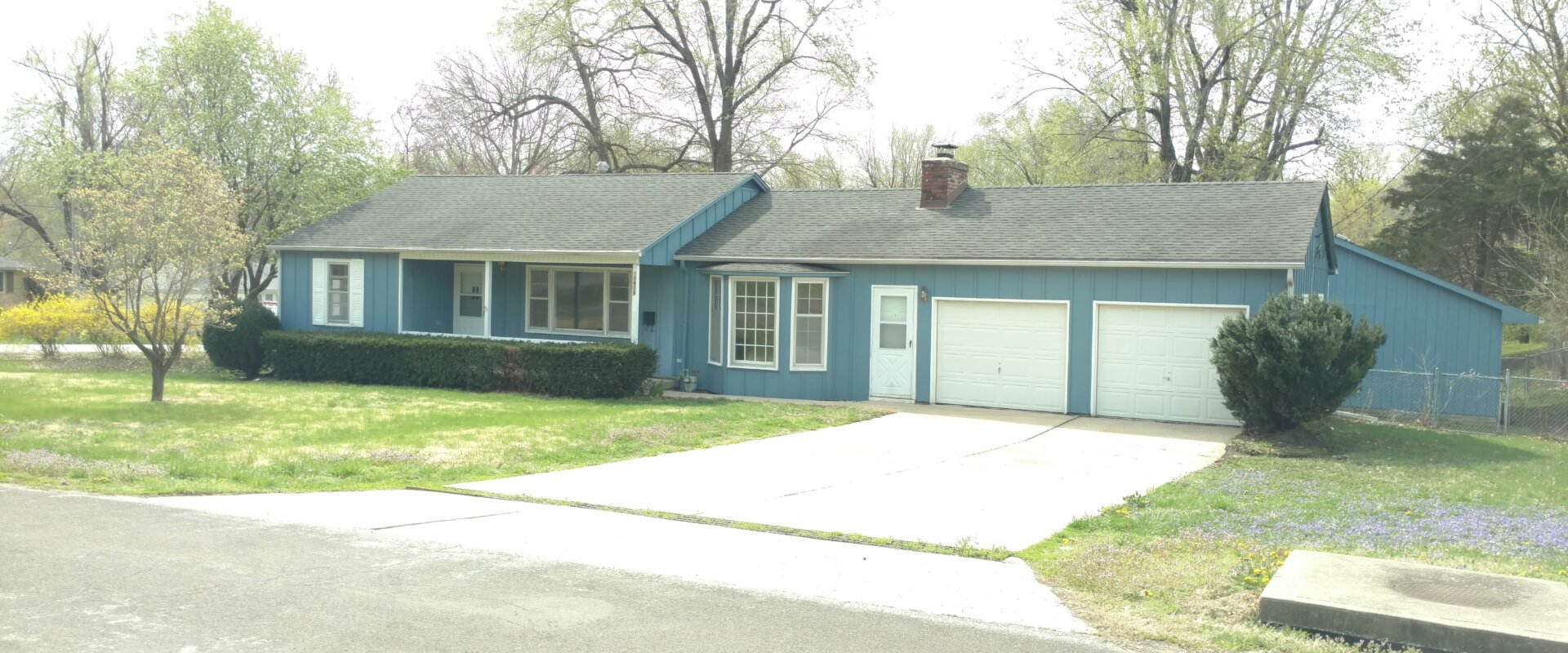 Blue house in raytown with 2 car garage