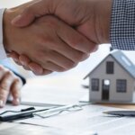 Handshake over signed paperwork needed to sell your house in Louisville, KY