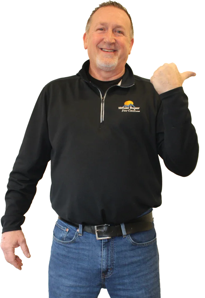 Chris from House Buyer For Cash pointing toward the company mission statement for buying houses in Toledo, Ohio.