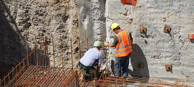 men building foundation