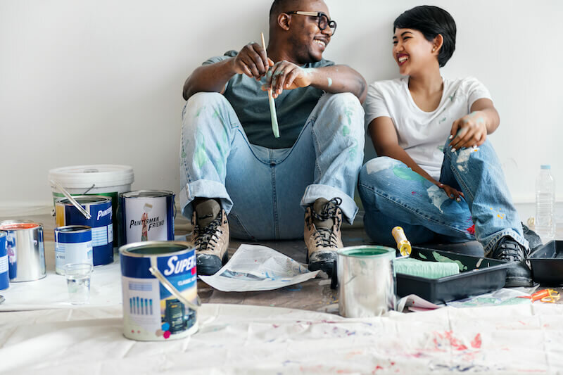 couple adding a fresh layer to their house wall