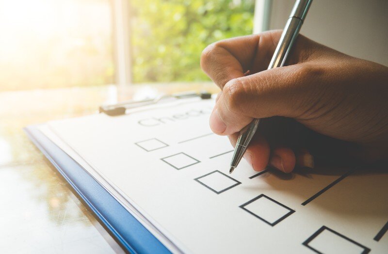 A homeseller going through a checklist before selling his home.