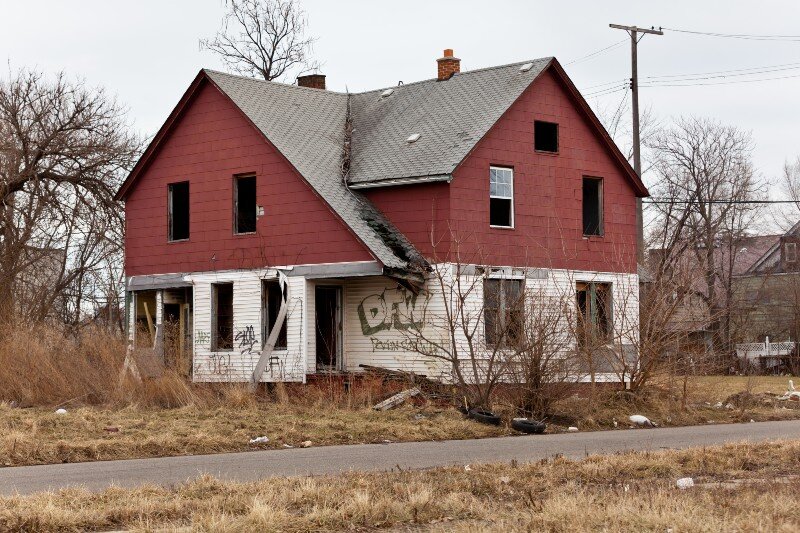 A badly damaged uninhabitable home goes for sale.