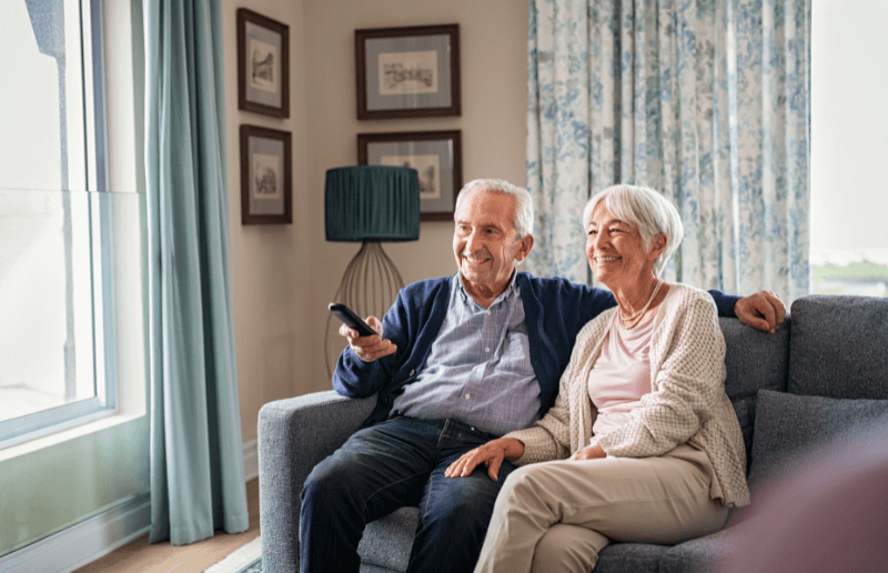 Two senior homeowners watching HGTV home renovation shows