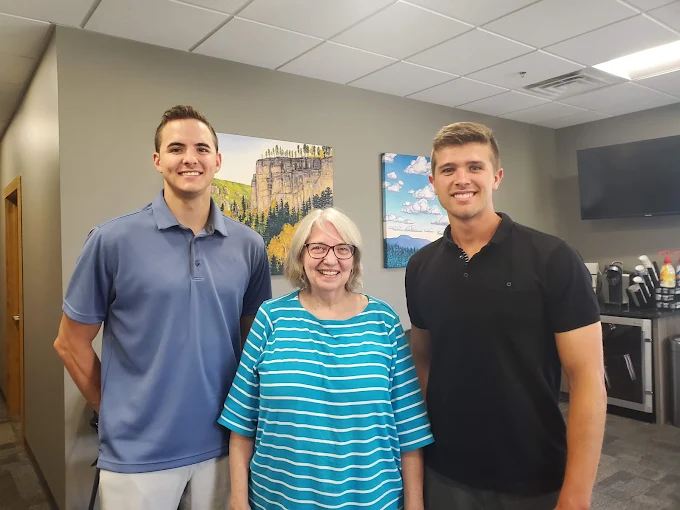 Three adults in an office, from Dakota Home Buyers’ Google business profile