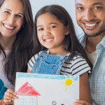 How To Sell Your Home for the Right Price This Summer | happy mixed family holding drawing