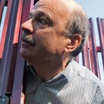 Home Improvements That Could Turn Your Neighbors Into Your Enemies | man looking out of fence